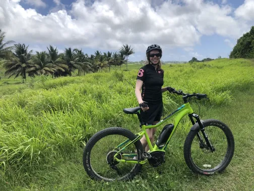 Monica riding her bike on a trip.